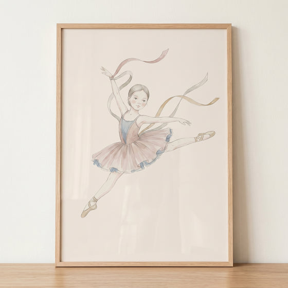 Flowing silk ribbon ballerina artwork of a leaping dancer in a pink tutu and pointe shoes, set in a light wood frame.