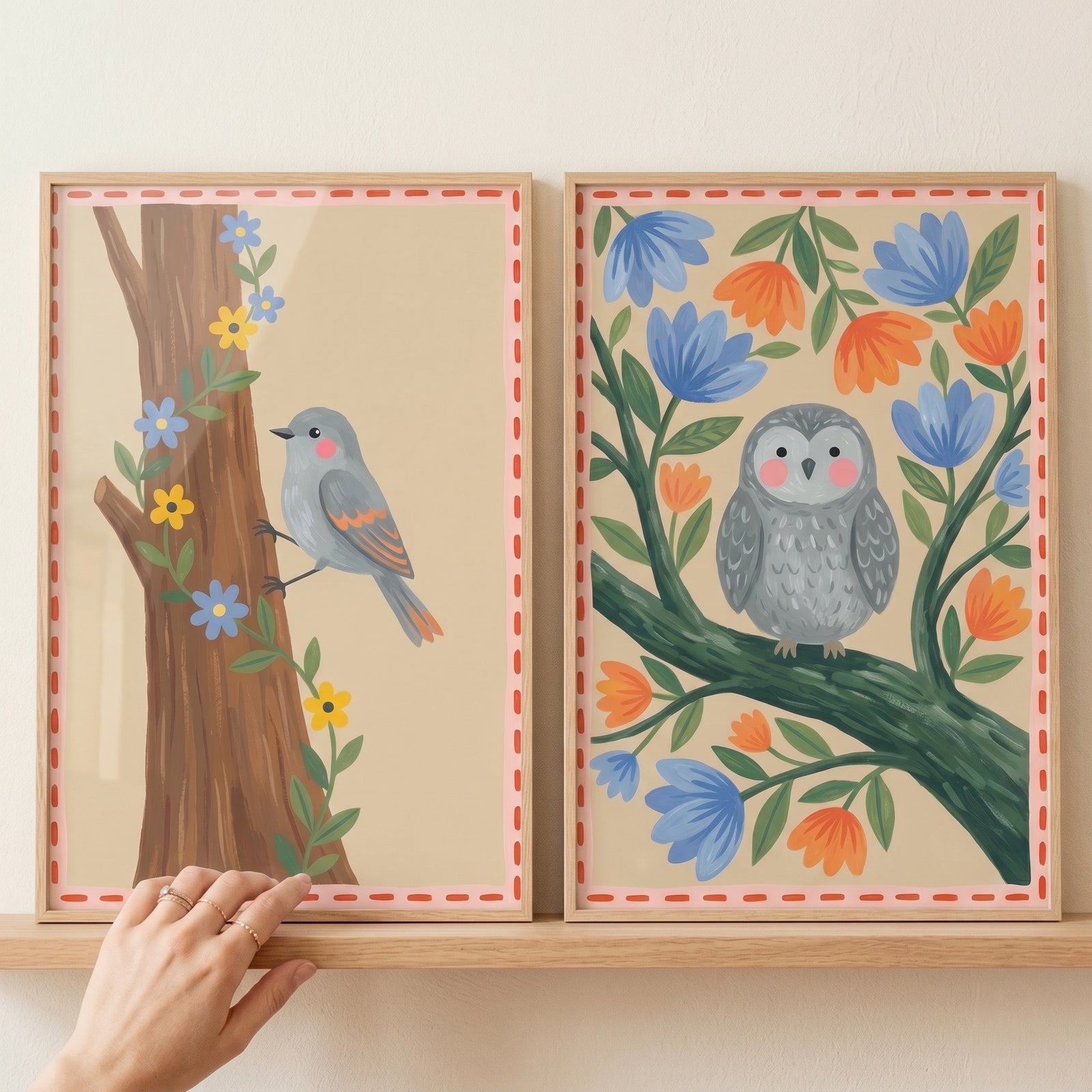 A folk floral forest bird wall art set of 2 featuring an owl and songbird among colorful flowers on a wooden shelf.