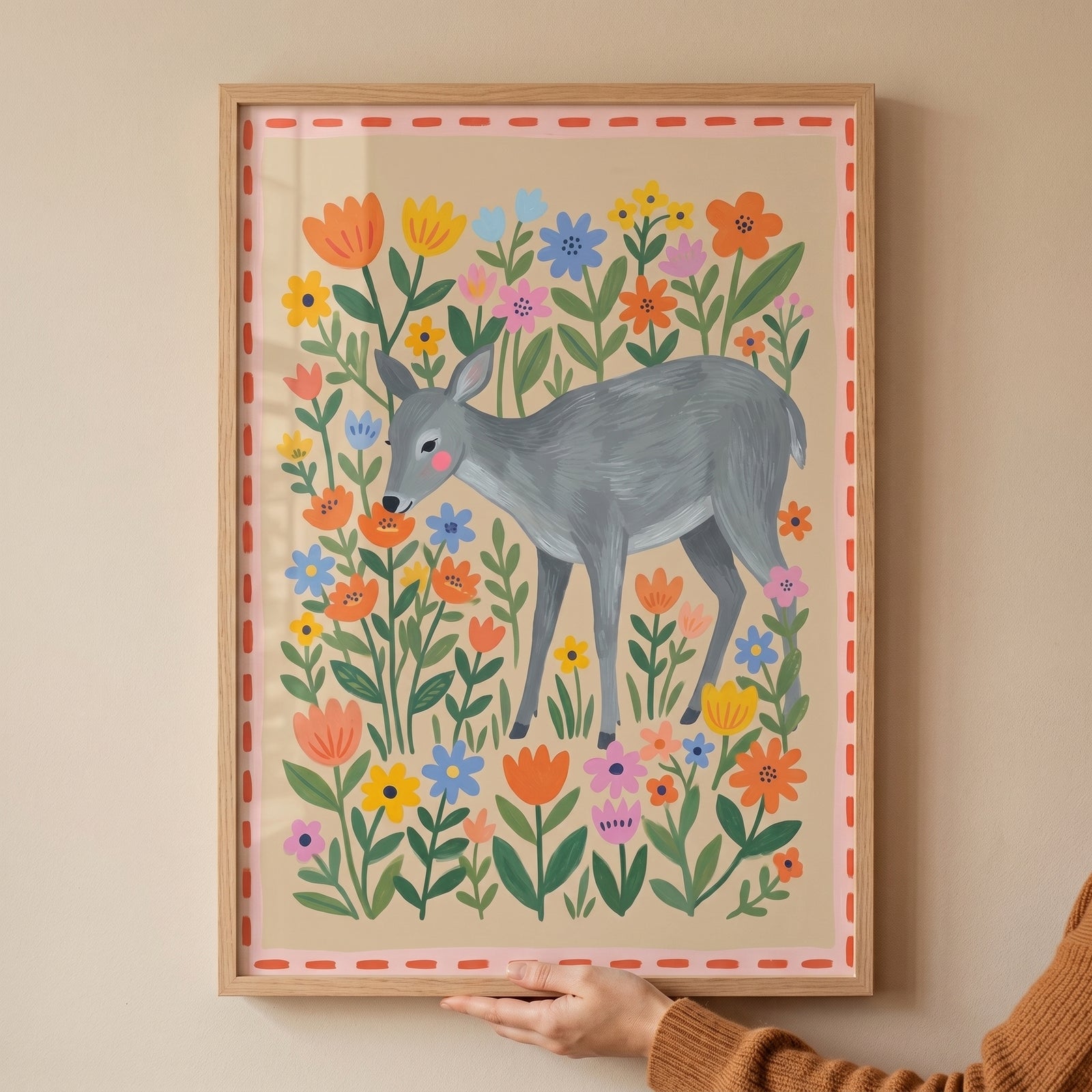 Framed folk floral garden deer wall art with a gray deer surrounded by colorful flowers and a pink dashed border.