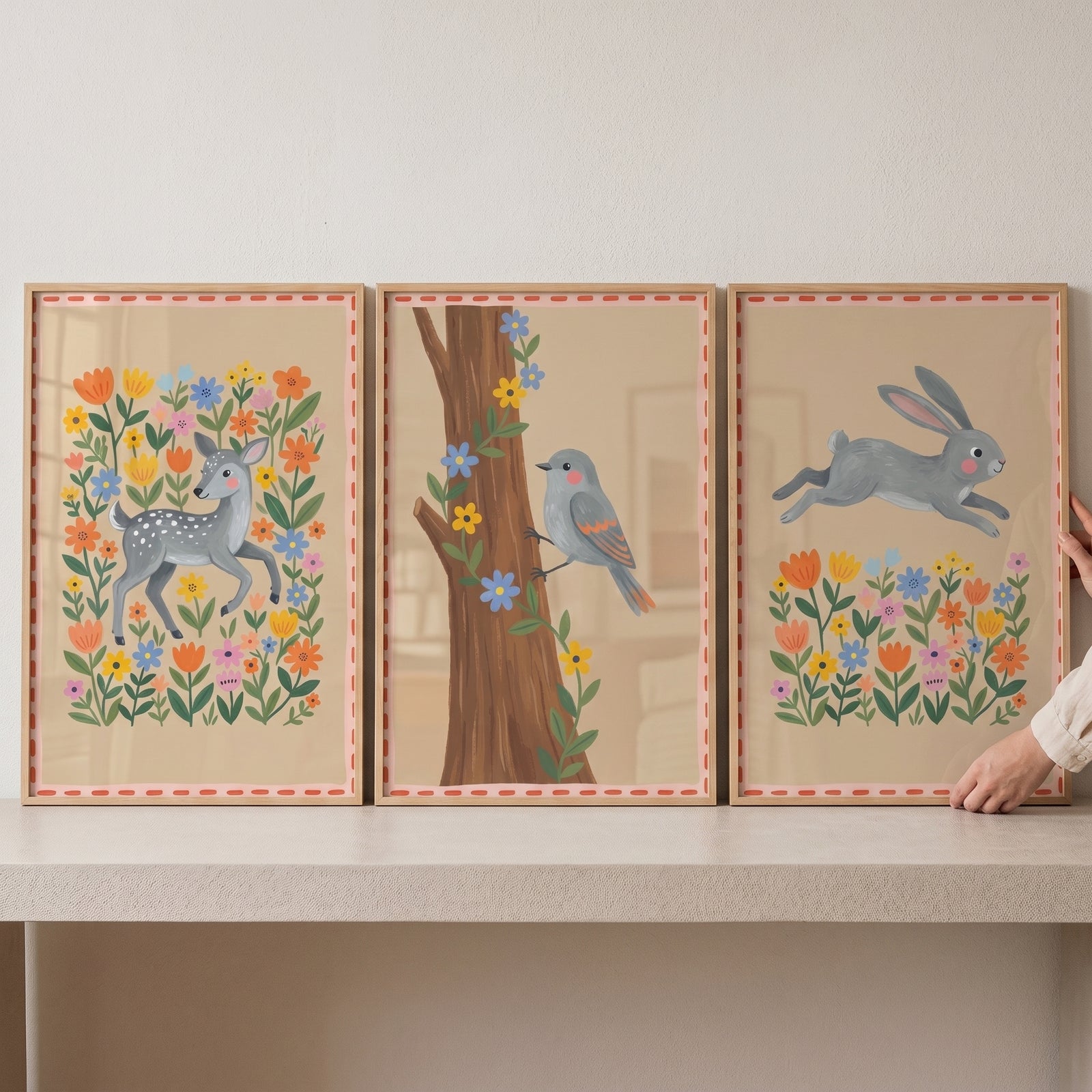Folk floral woodland animals wall art set of 3 featuring a deer, bird, and rabbit among vibrant meadow flowers.