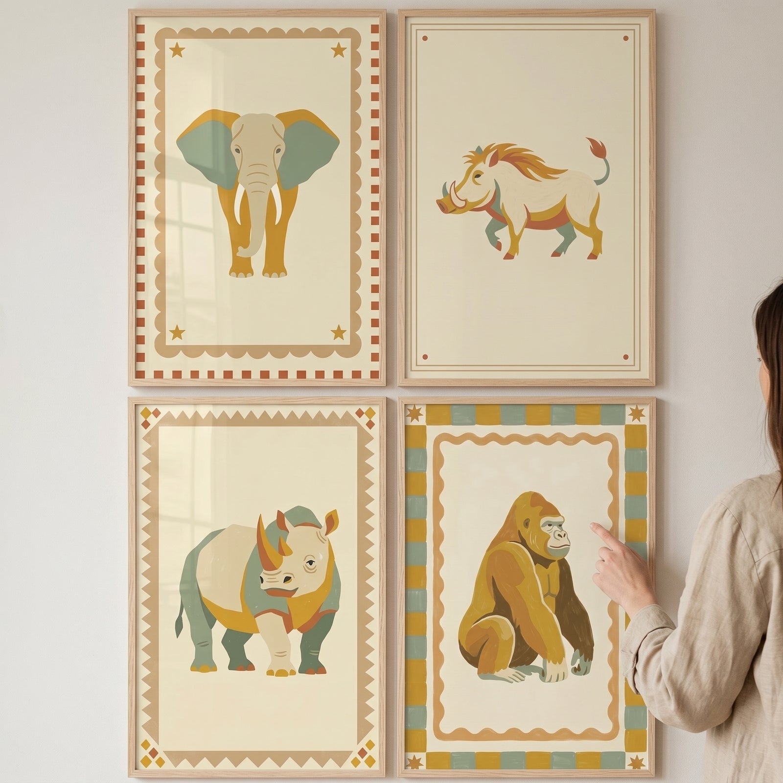 A person points at folk retro safari animal wall art set of 4 featuring an elephant, warthog, rhinoceros, and gorilla.