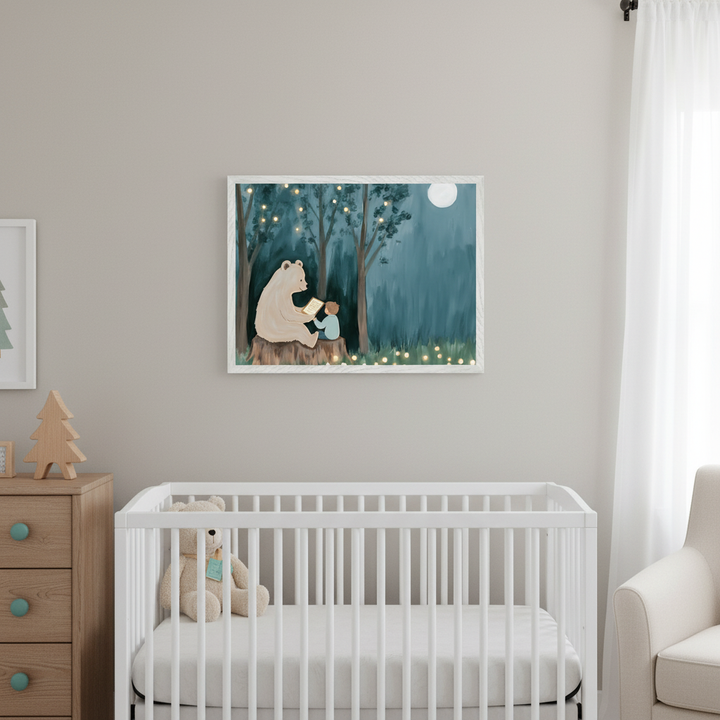 Modern nursery with a white crib, wooden dresser, and armchair. A framed illustration of a bear and child reading on a tree stump in a forest at night with string lights and a moon hangs centered above the crib.