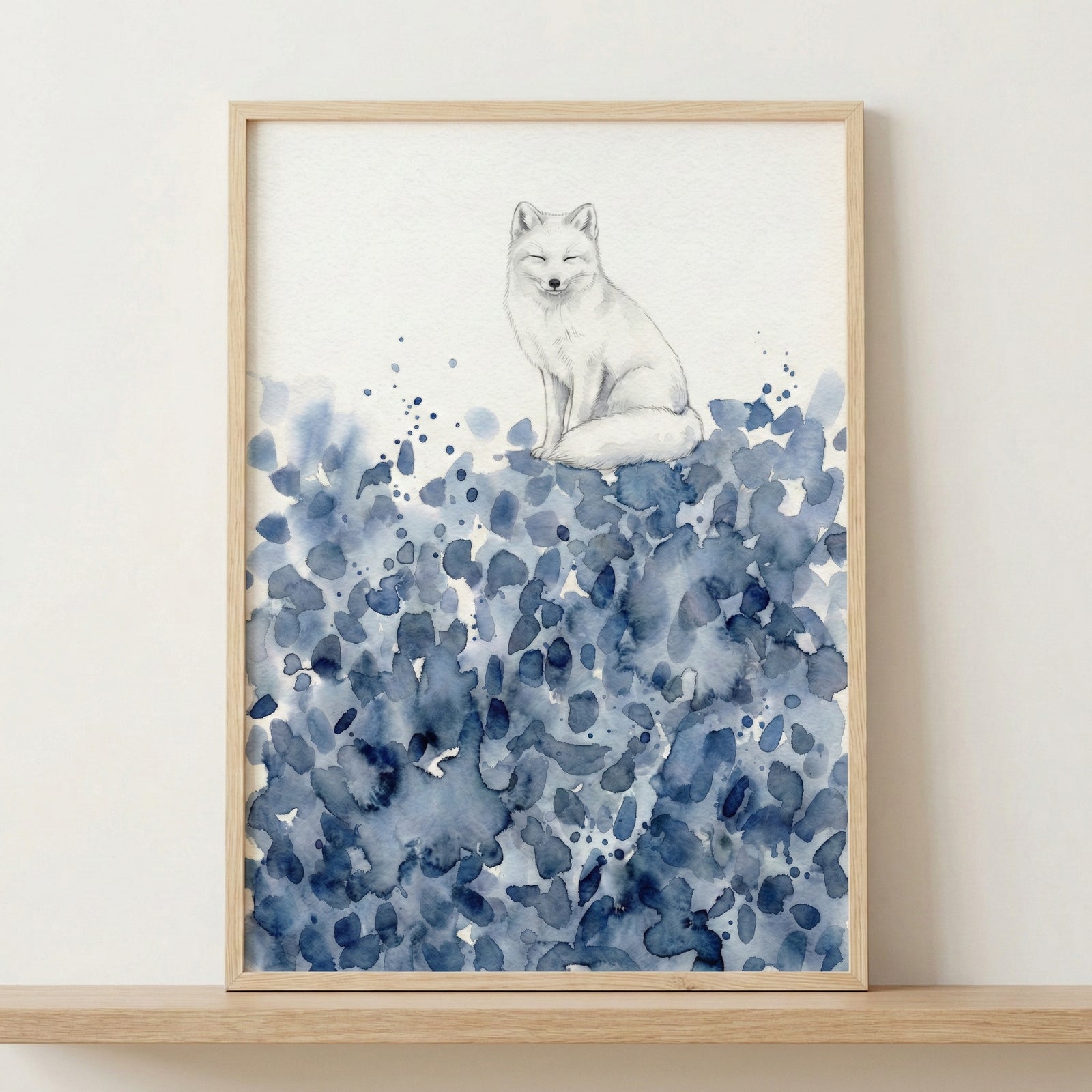 Framed watercolor painting of a white fox sitting calmly atop abstract blue brushstrokes, hung above a wooden crib in a softly lit nursery. The peaceful animal artwork adds a dreamy, serene touch to the baby’s room.