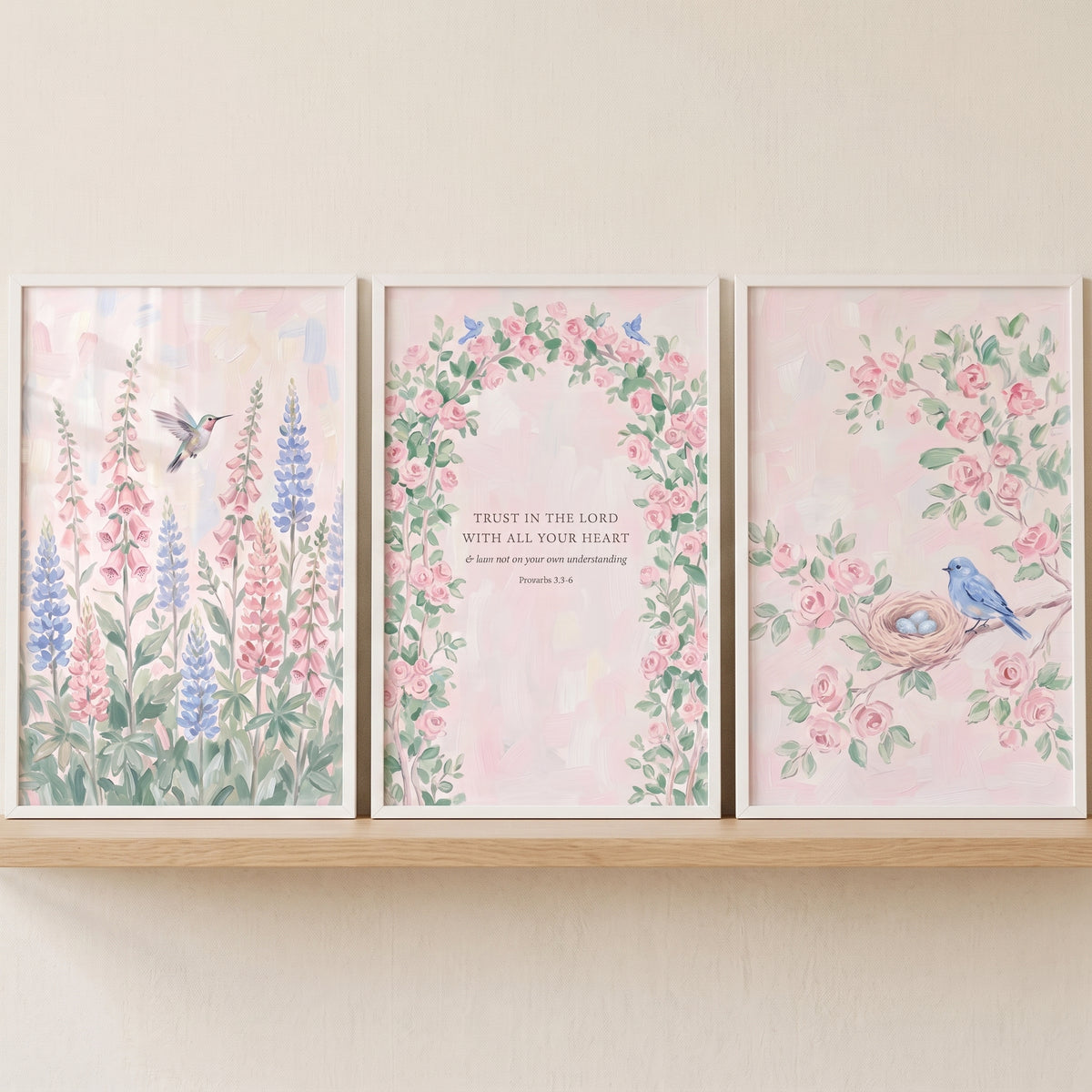 French country flower wall art set of 3 displays pastel watercolor florals, birds, and scripture on a wooden shelf.