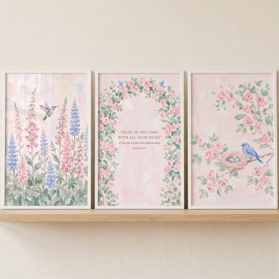 French country flower wall art set of 3 displays pastel watercolor florals, birds, and scripture on a wooden shelf.