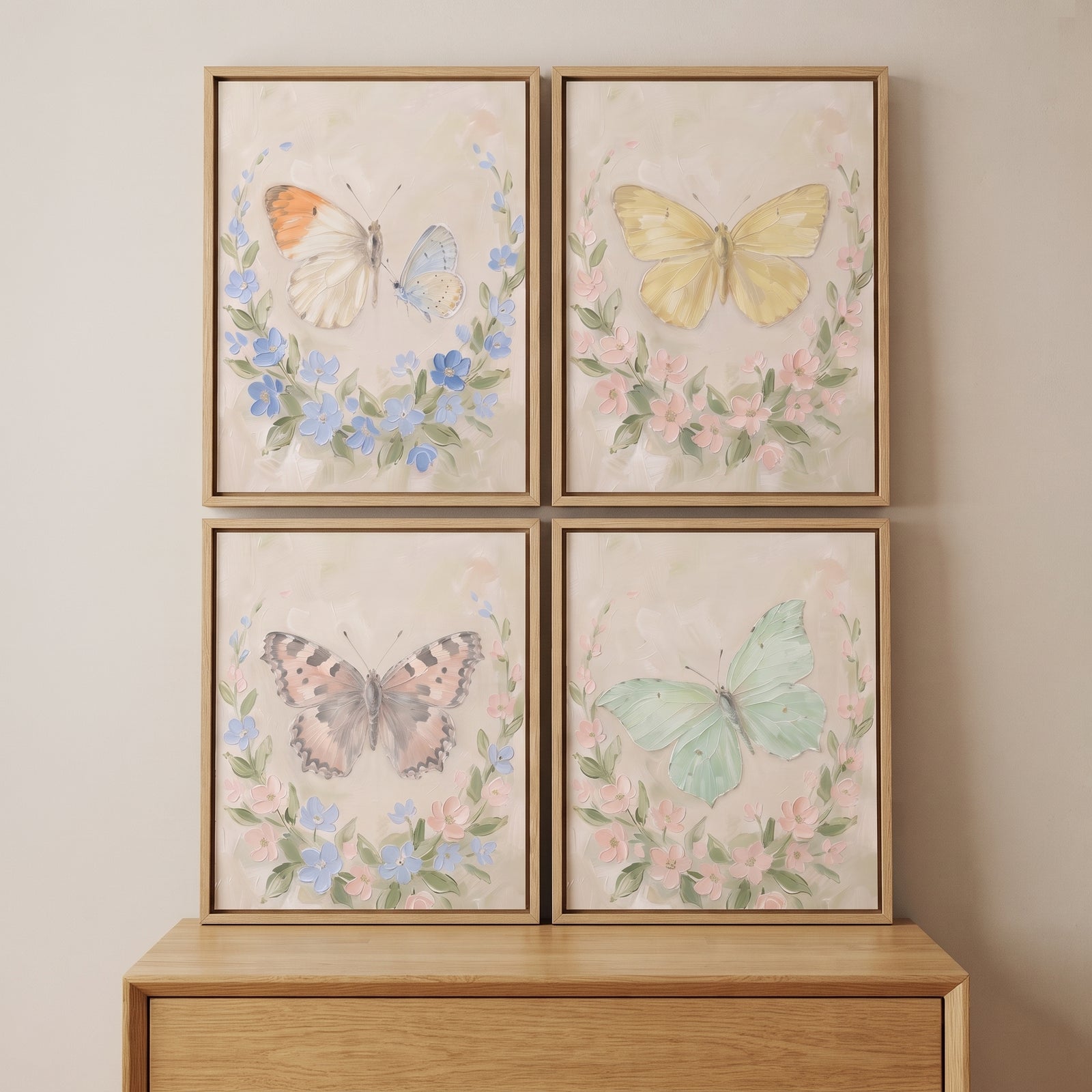 French provence wreath butterfly wall art set of 4 hangs on a wall above a light wood dresser.