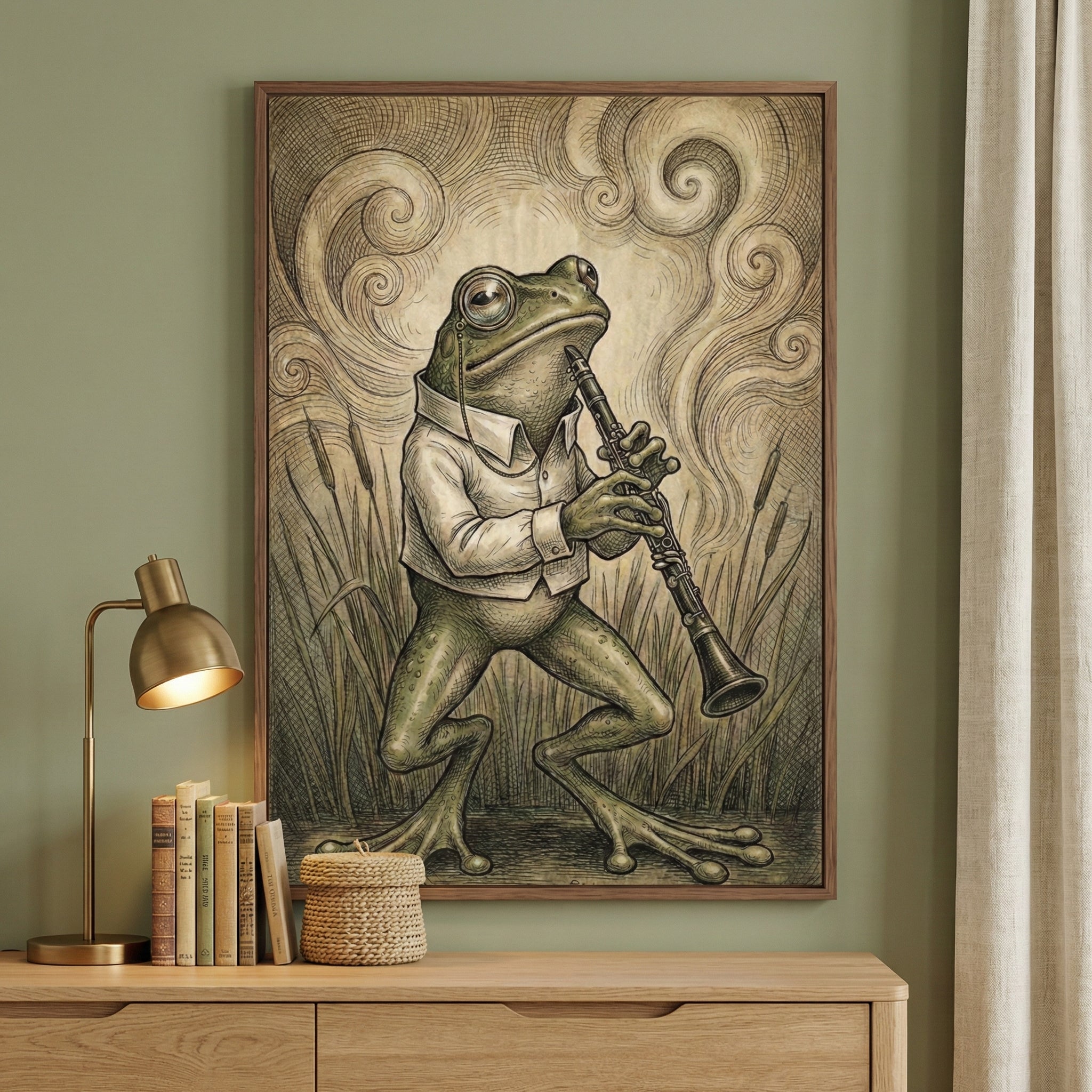 Whimsical framed artwork of a monocled frog dressed in a white shirt, standing on two legs while playing a clarinet in a marshy field of cattails. Swirling background lines evoke a dreamy, musical atmosphere, and the piece hangs above a light wood dresser with books, a woven basket, and a gold reading lamp, creating a cozy, artistic nook.