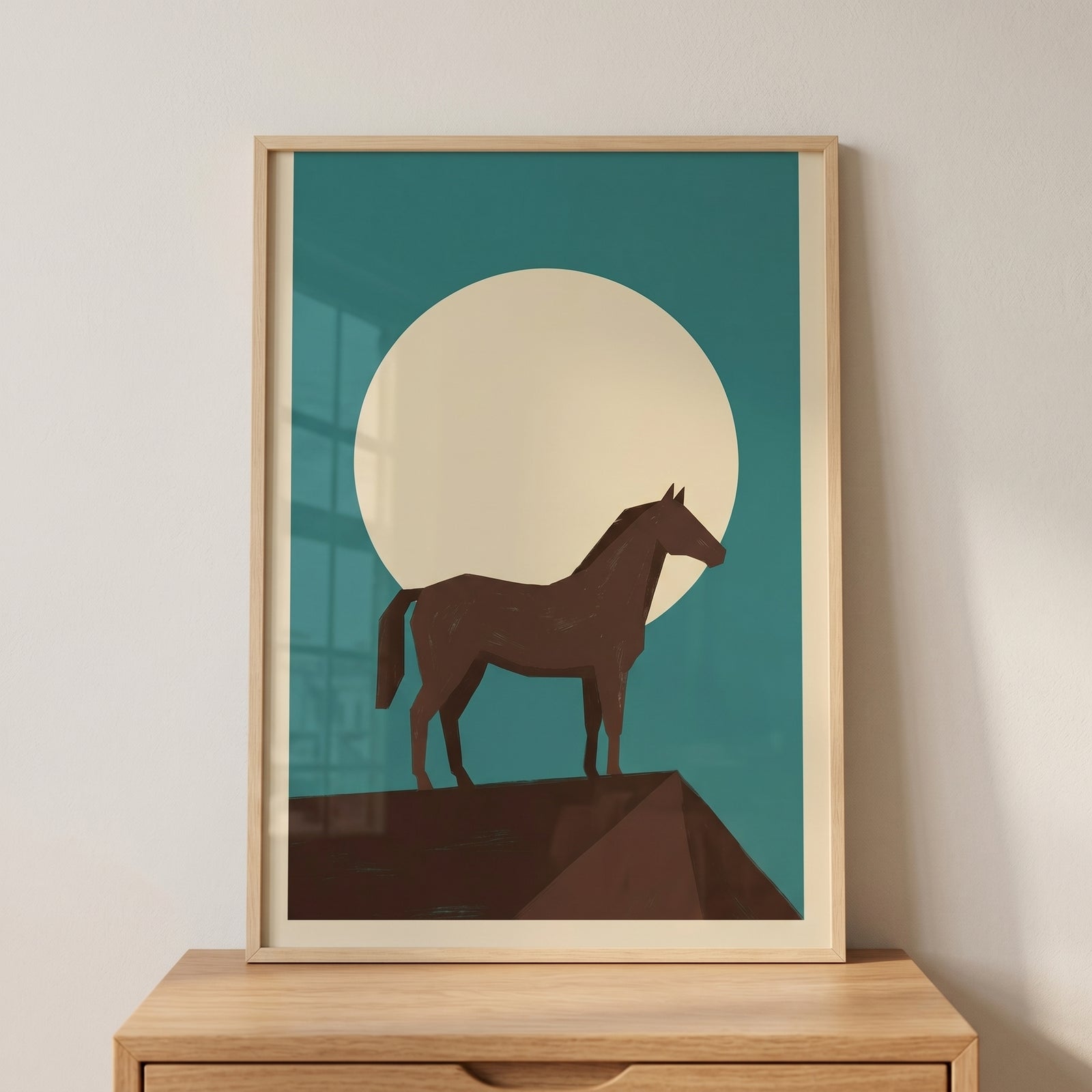 Full moon brown horse wall art in a wood frame on a cabinet shows a minimalist horse on a peak against a moon and teal sky.