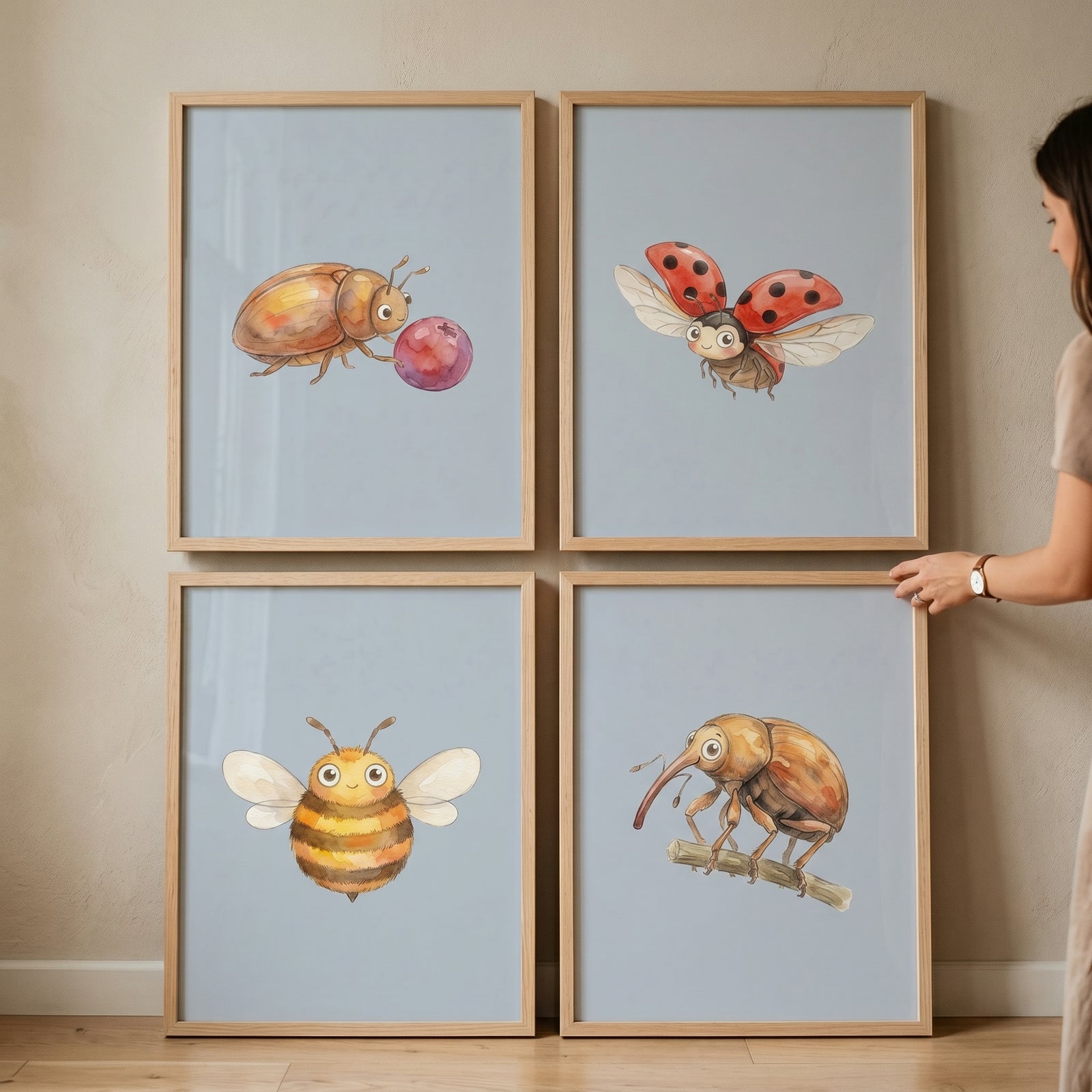 A person displays a garden bug wall art set of 4 featuring a ladybug, honeybee, and beetles in light wood frames.