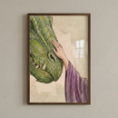 A framed illustration featuring a close-up of a green, scaly dragon's head. A slender hand, emerging from a textured purple sleeve, reaches out to gently touch the creature's snout. The artwork utilizes a watercolor and colored pencil style, with delicate washes of color and visible linework on a neutral background. The piece is mounted in a dark wooden frame and displayed against a plain, light-colored wall.