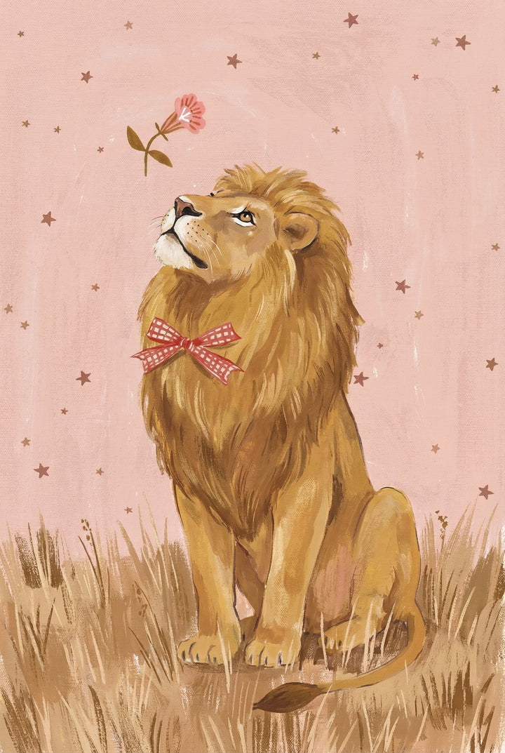 A warm illustration of a golden lion sitting in tall grass wearing a red gingham bow and gazing up at a floating pink flower against a soft pink star-speckled background.


