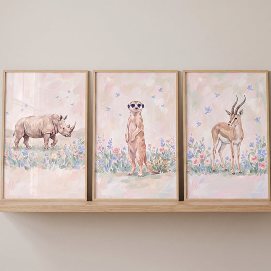 Gentle meadow safari animals wall art set of 3 featuring a rhino, meerkat, and gazelle in a soft floral landscape.