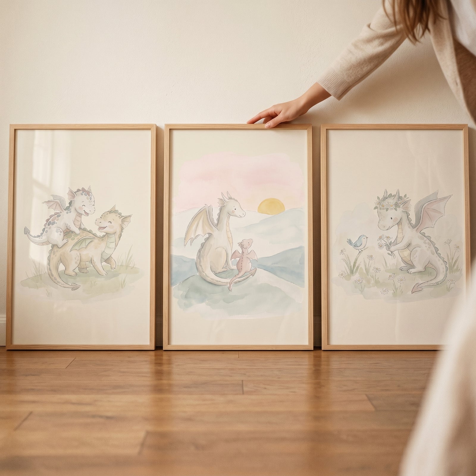 Gentle sage baby dragon wall art set of 3 features watercolor-style illustrations of dragons in light wood frames.
