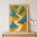 Framed geometric mountain brown horse wall art shows a brown horse on a winding white path between teal and yellow peaks.