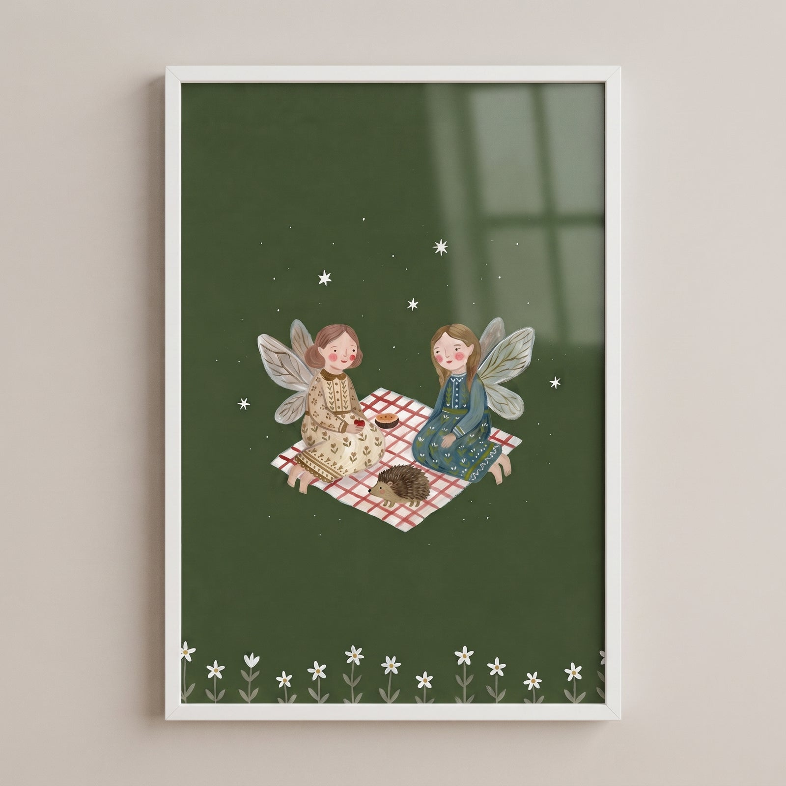 Gingham blanket picnic fairies wall art of two fairies and a hedgehog on a dark green background with stars and flowers.