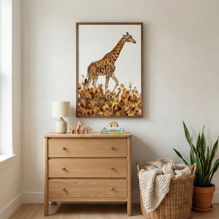 Whimsical watercolor giraffe art print framed on a nursery wall above a wood dresser.