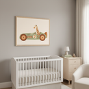 Modern nursery with a white crib, light wood dresser, and cream armchair. A large framed illustration of a cartoon giraffe driving a green race car with '7' and 'FACALE' hangs above the crib.
