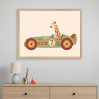Modern kid's room with a light wood dresser. A framed print of a cartoon giraffe in a green race car with number 7 and "FACALE" is centered above the dresser. A lamp and wooden giraffe figurine are on the dresser.