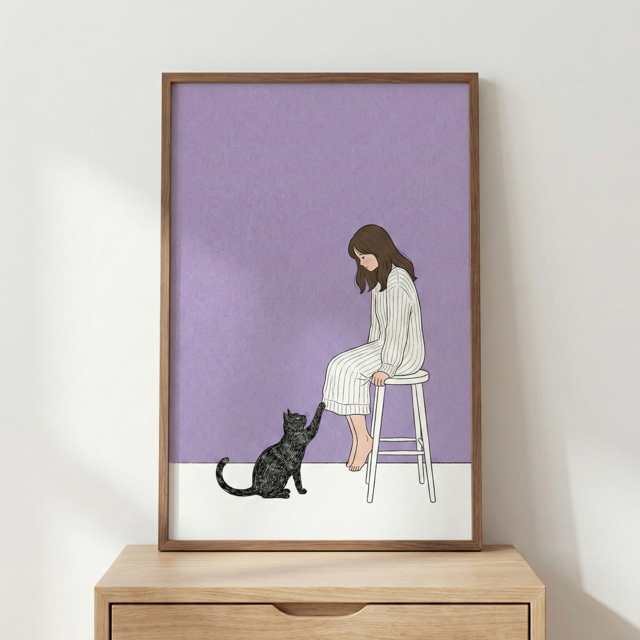 A minimalist illustration depicts a young woman with long brown hair sitting on a white stool. She wears a white striped dress and looks down at a black cat that is reaching up to touch her knee with its paw. The background features a solid lavender wall above a white floor. The framed artwork rests on a light-colored wooden dresser against a plain white wall, creating a serene and cozy atmosphere.