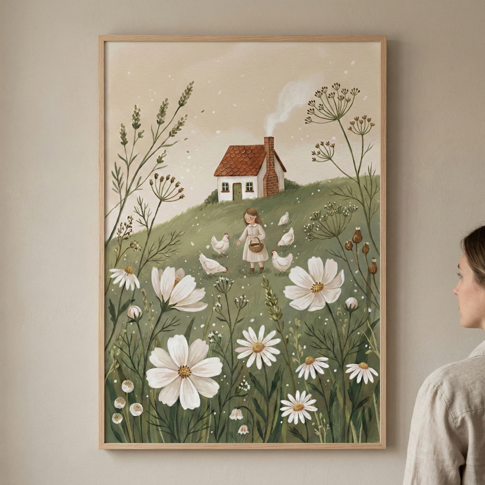 A vertical framed illustration in a folk-art style depicts a serene countryside scene. In the center, a young girl in a pale dress holds a basket while standing on a grassy hill surrounded by white chickens. Behind her, a small white house with a red-brown roof has smoke curling from its chimney. The foreground features large, stylized white flowers and tall botanical stems. To the right of the frame, a person is partially visible from the side, looking at the art on a neutral wall.