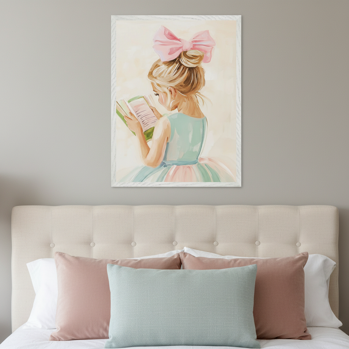 Kid's bedroom with an upholstered beige headboard. A framed painting of a young girl with a pink bow, wearing a pastel dress and reading a book, hangs centered above the headboard.