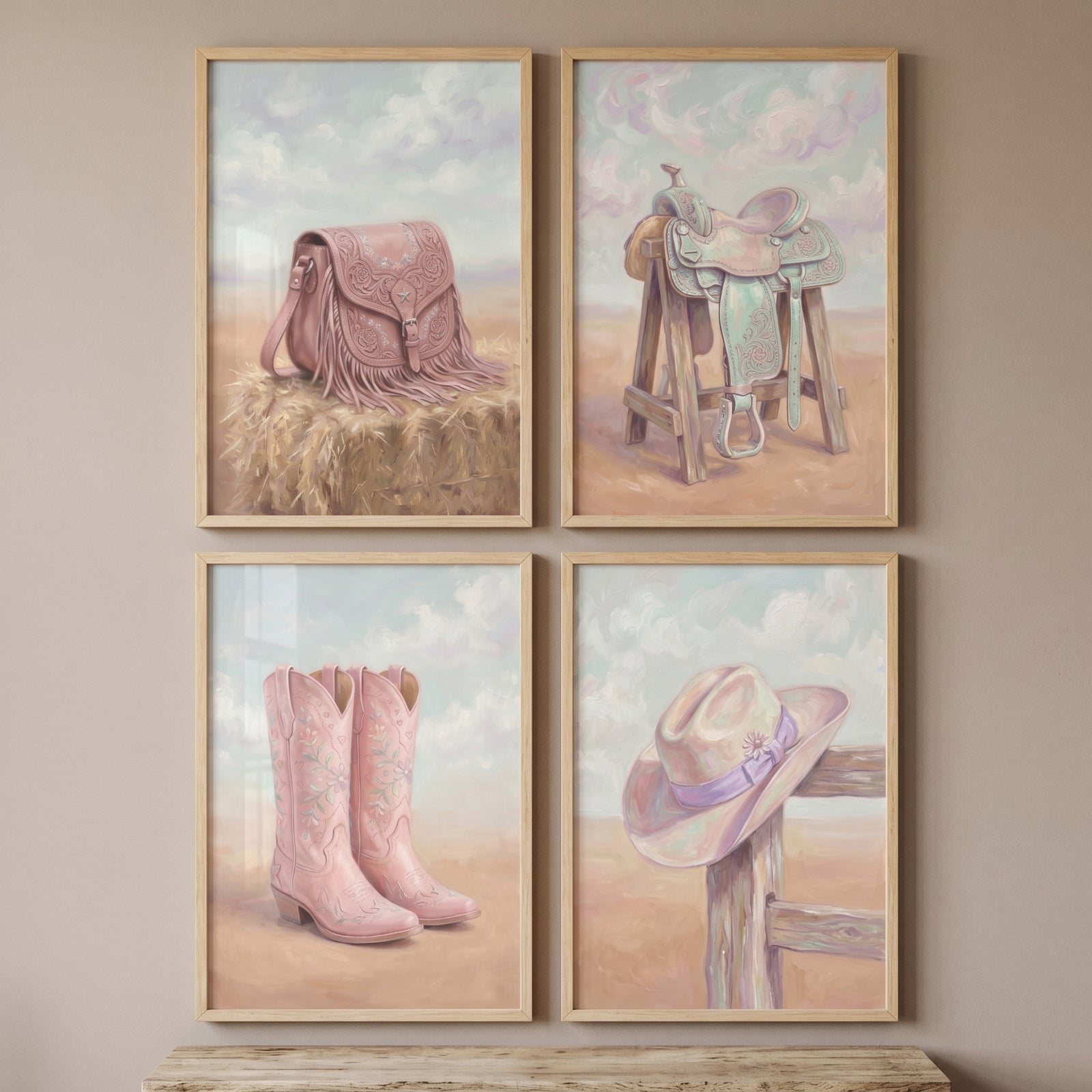 Girly pink western gear wall art set of 4 with a fringed bag, saddle, boots, and hat in a soft desert landscape.