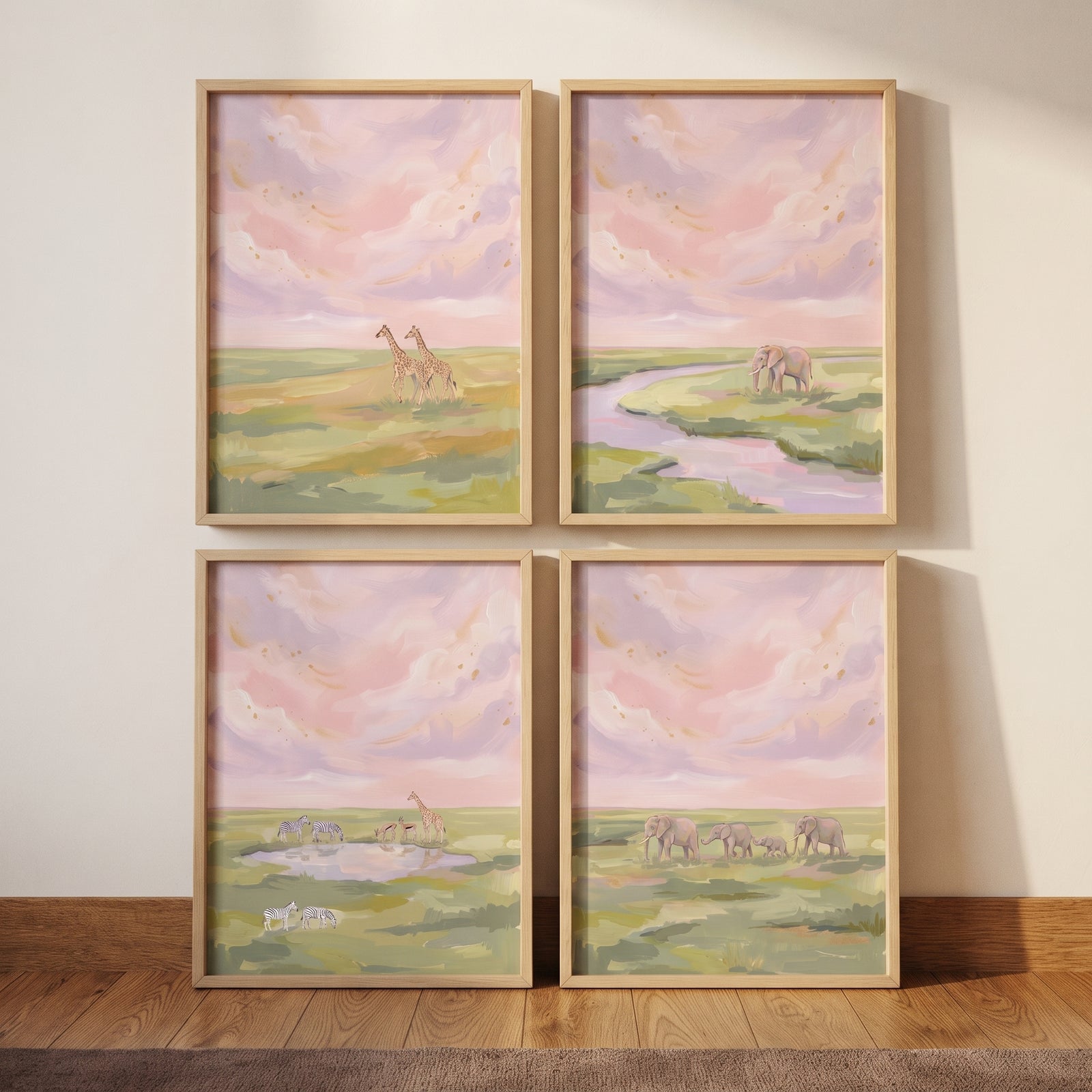 Gold blush safari animals wall art set of 4 showing giraffes and elephants in a grassy landscape under a soft pink sky.