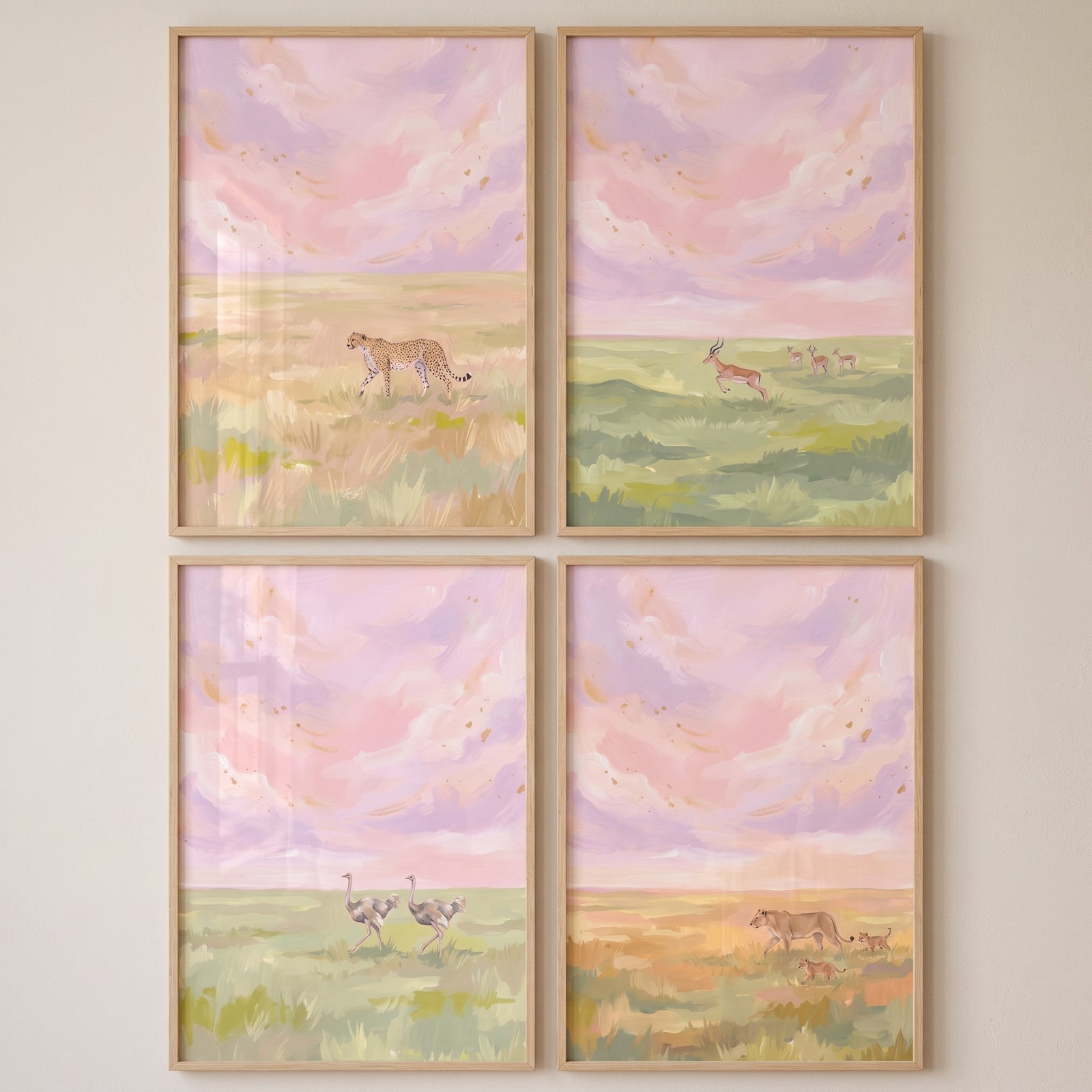 Gold flecked savanna animals wall art set of 4 featuring a cheetah, gazelles, ostriches, and lions in pastel landscapes.