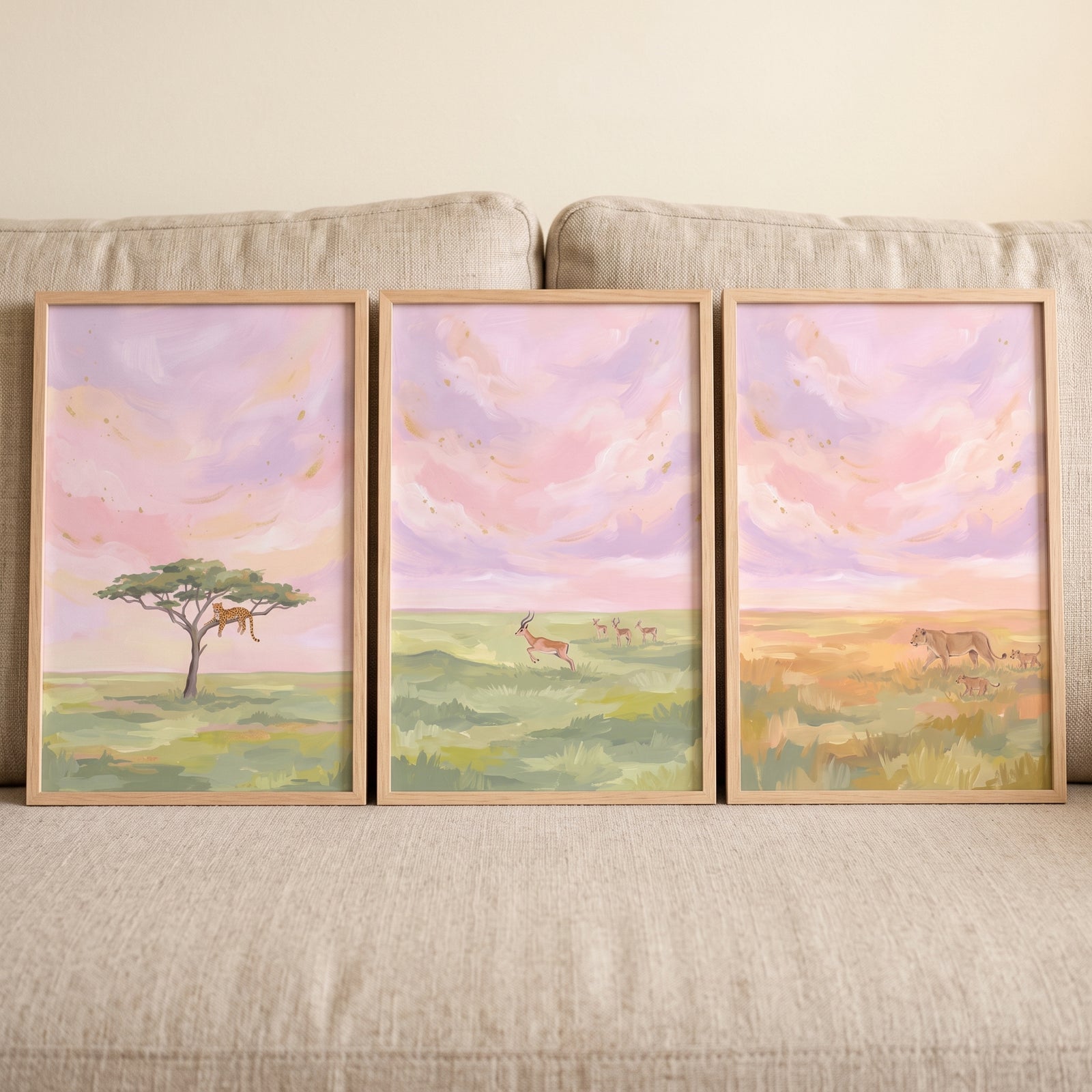 Gold leaf safari animals wall art set of 3 with a leopard, antelope, and lions under a pastel pink and purple sky.