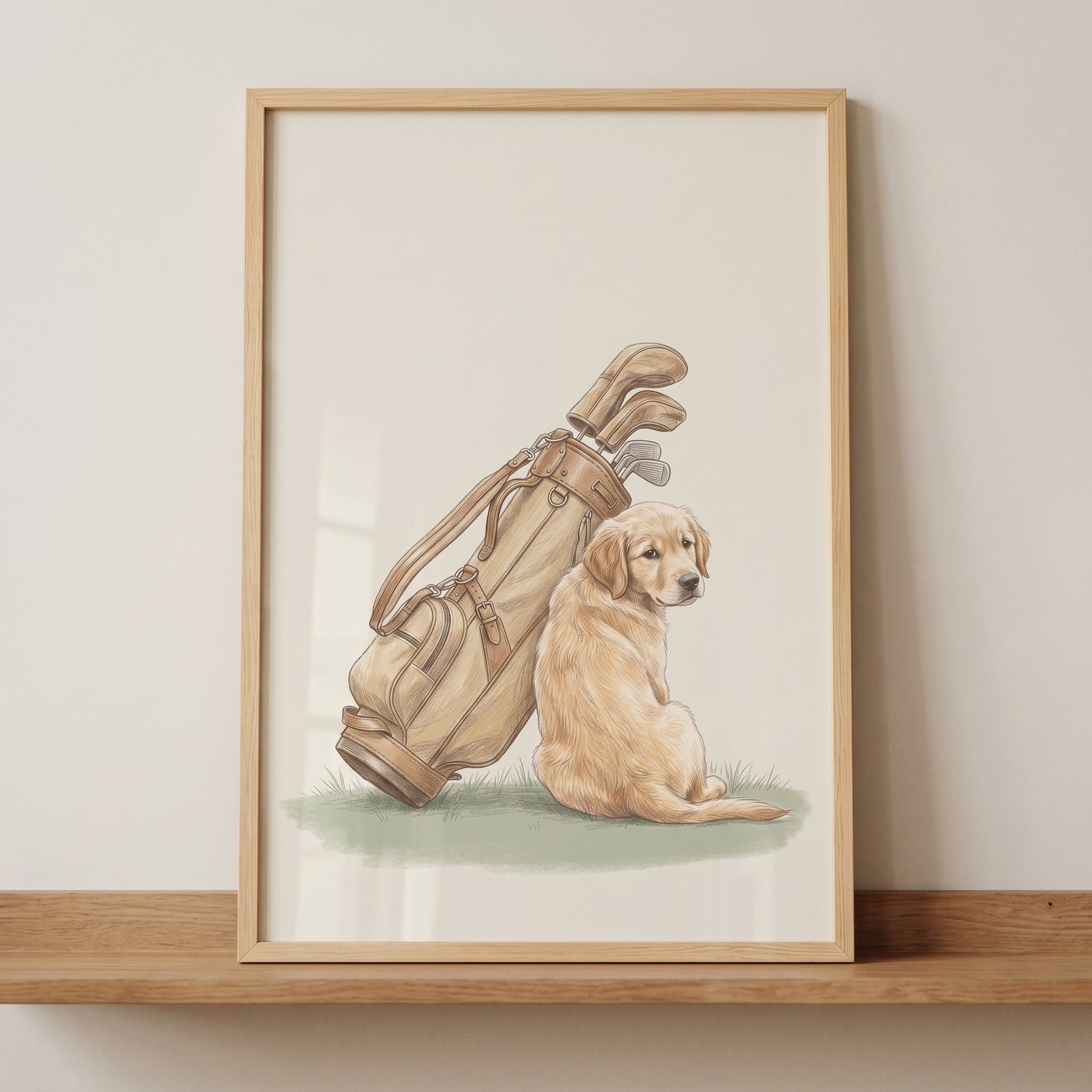 Golf bag golden retriever dog wall art in a wooden frame shows a puppy sitting next to a vintage tan golf bag.