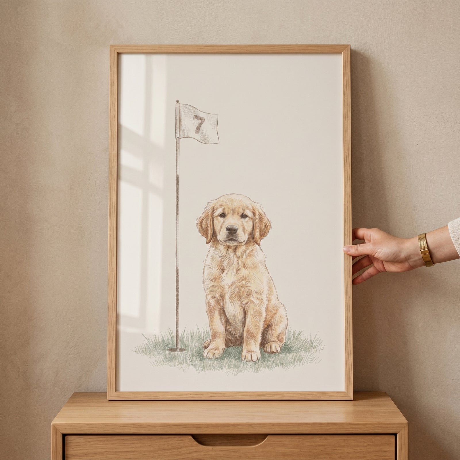 Framed golf flag golden retriever dog wall art shows a puppy sitting on grass next to a flag with the number seven.