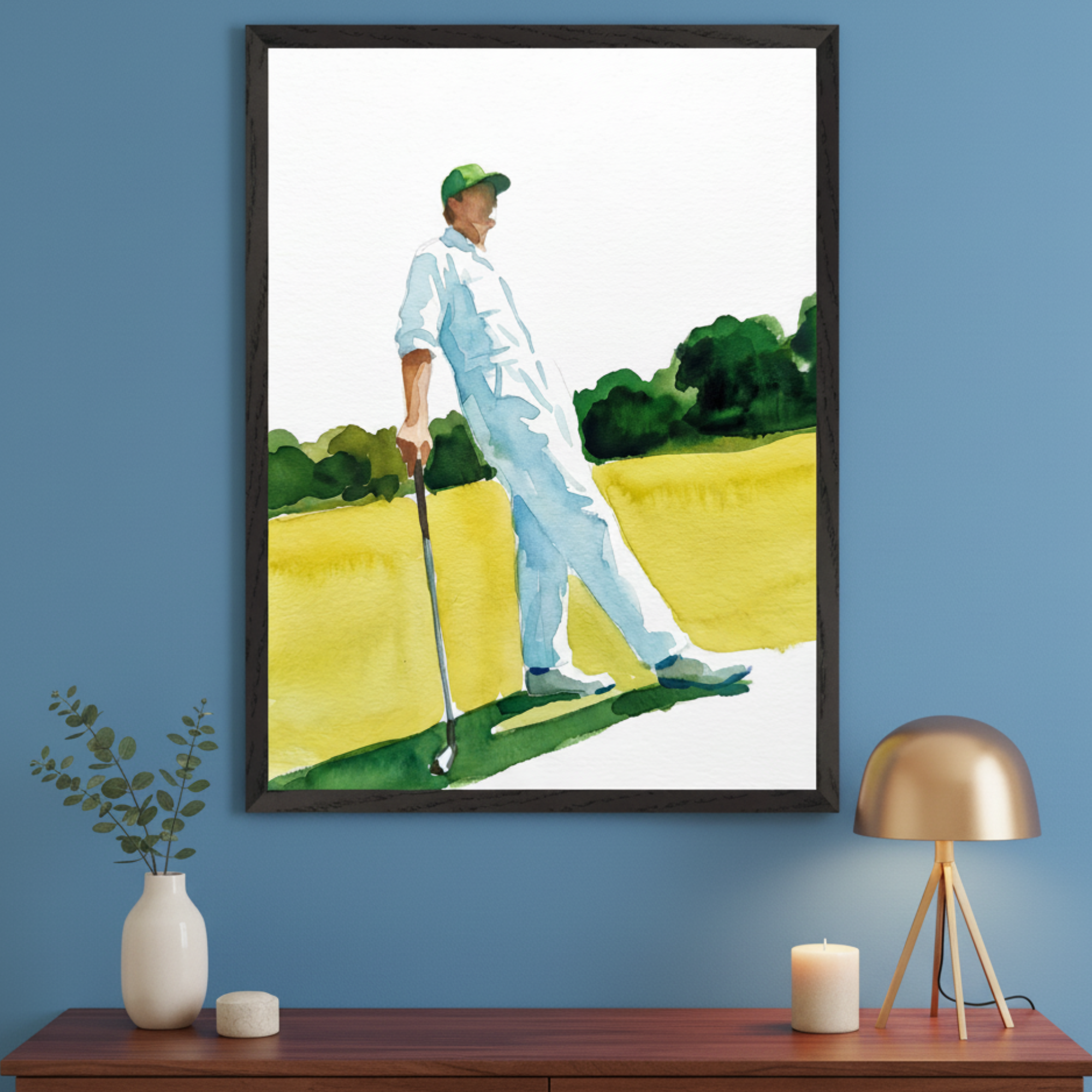 Modern room with a blue wall and a brown wooden dresser. A large framed watercolor painting of a golfer in white and a green cap on a golf course hangs centered above the dresser.