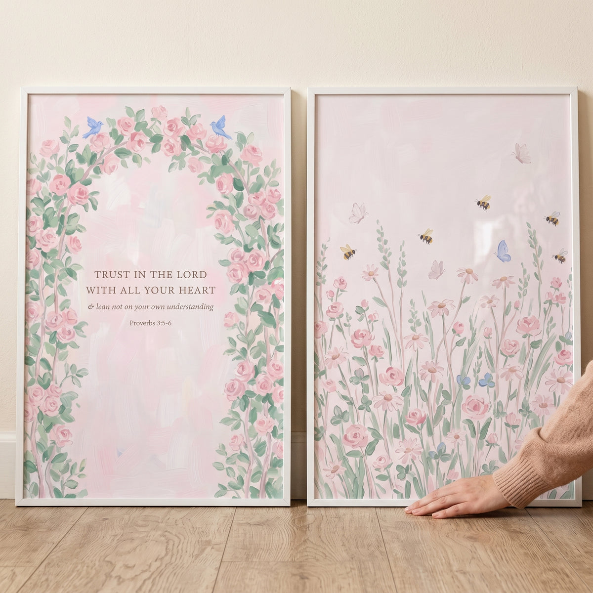 Graceful blush pink garden wall art set of 2 with a floral arch, scripture, and a meadow of wildflowers and butterflies.