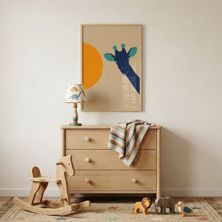 A child's nursery featuring a light wood three-drawer dresser against a cream wall. Above hangs a framed illustration of a stylized blue giraffe with an orange circle. On the dresser are a lamp with a dinosaur-patterned shade and a multi-colored striped knit blanket. A wooden rocking horse stands on a star-patterned rug in front of the dresser, alongside small wooden toys of a lion, an elephant, and a bird.