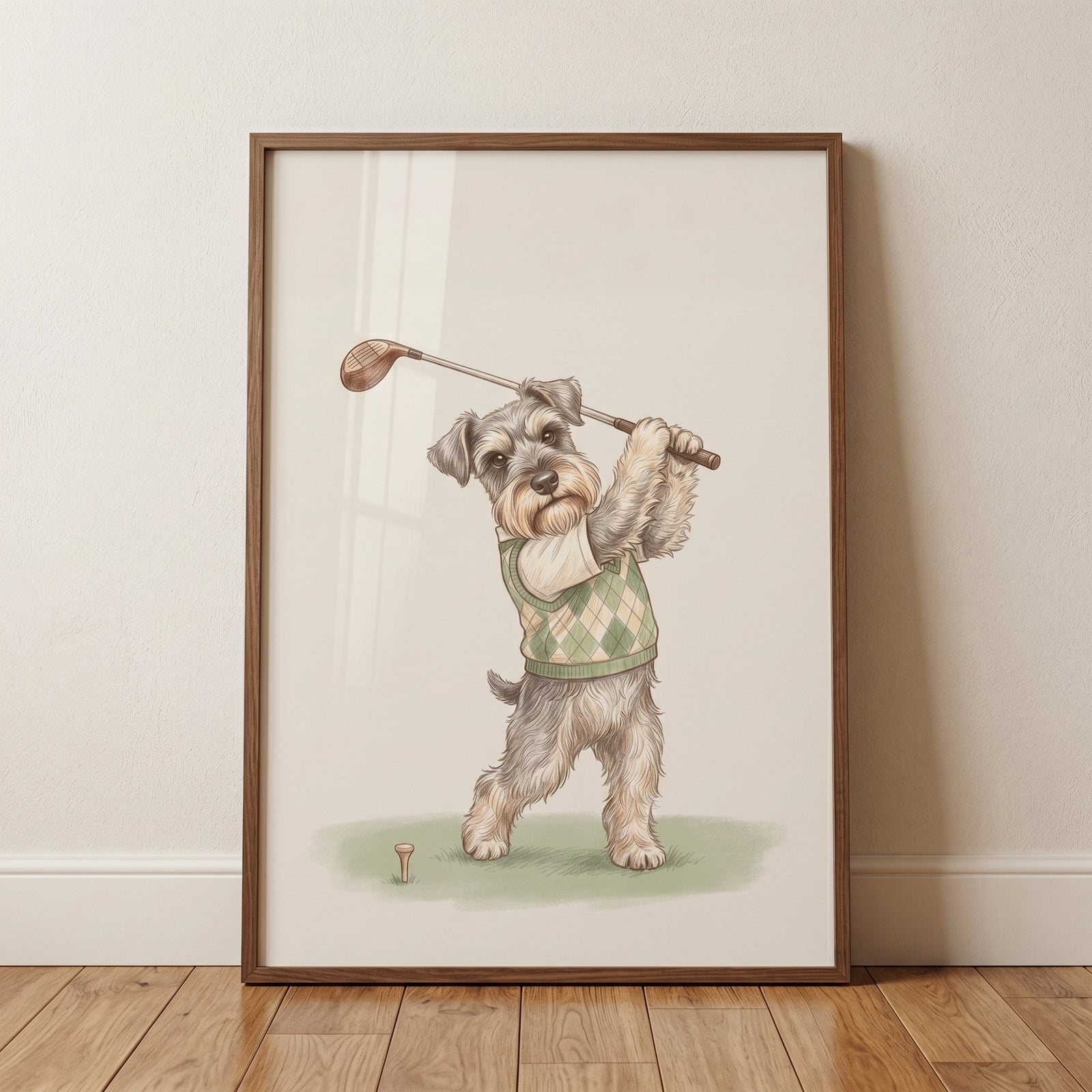 Green argyle sweater schnauzer dog wall art in a wood frame shows a gray dog swinging a golf club over a tee.