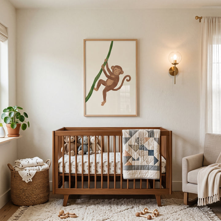 Green vine climbing monkey wall art hangs above a wooden crib in a neutral nursery with plush toys and a woven rug.