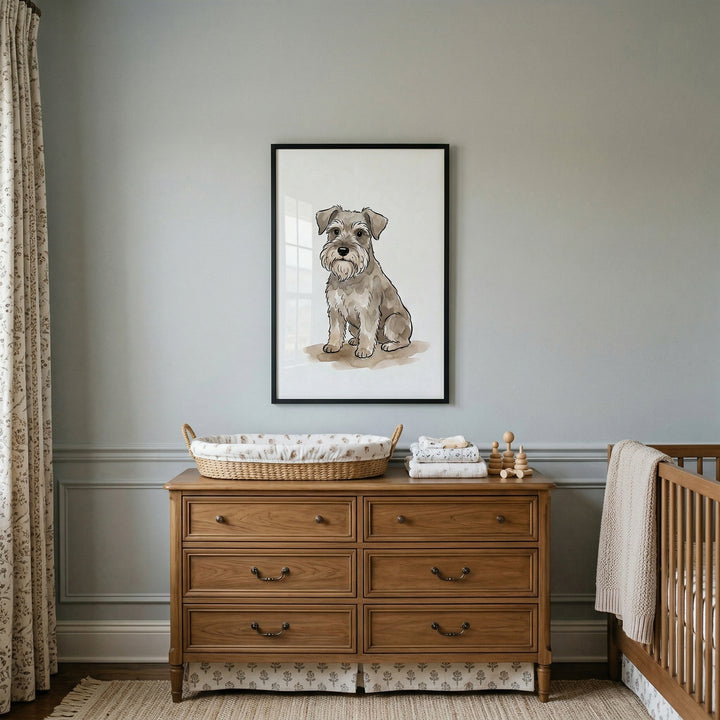 A classic nursery setup features a framed illustration of a wiry-haired dog breed hanging centrally on a soft, pale gray wall. Below the framed art sits a traditional wooden dresser with six drawers and dark metal handles. A fabric skirt with a subtle pattern lines the bottom of the dresser. 