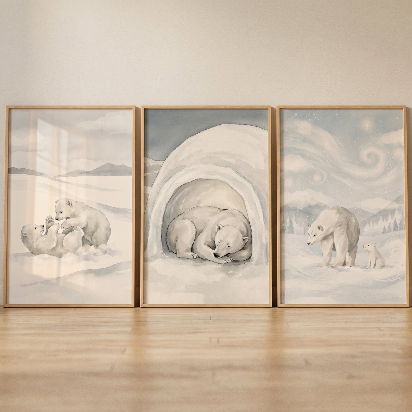 Grey watercolor polar bear wall art set of 3 showing bears playing, resting in a cave, and walking under a swirling sky.
