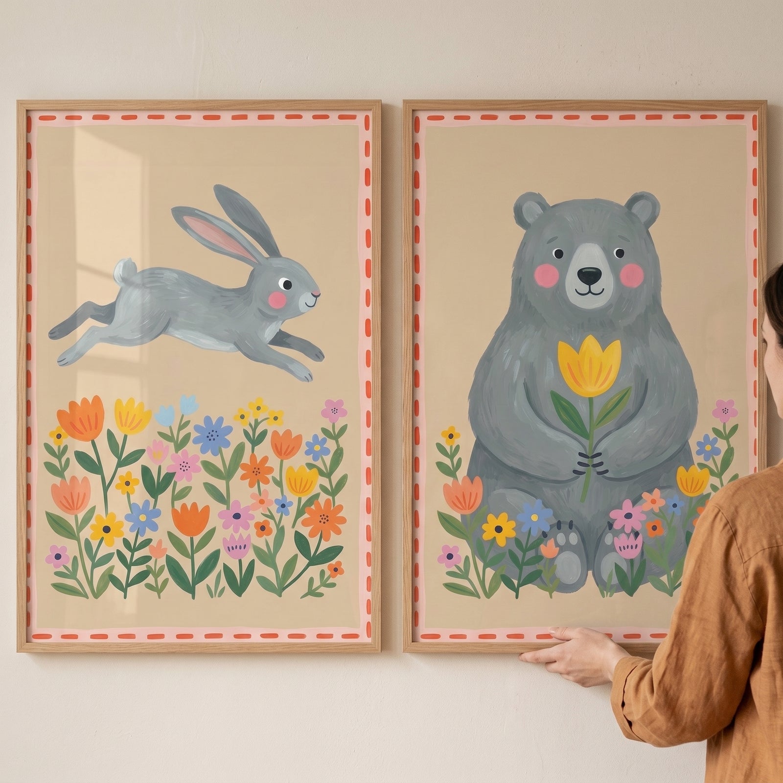 Grey whimsical forest animals artwork set of 2 featuring a leaping rabbit and a sitting bear among colorful flowers.