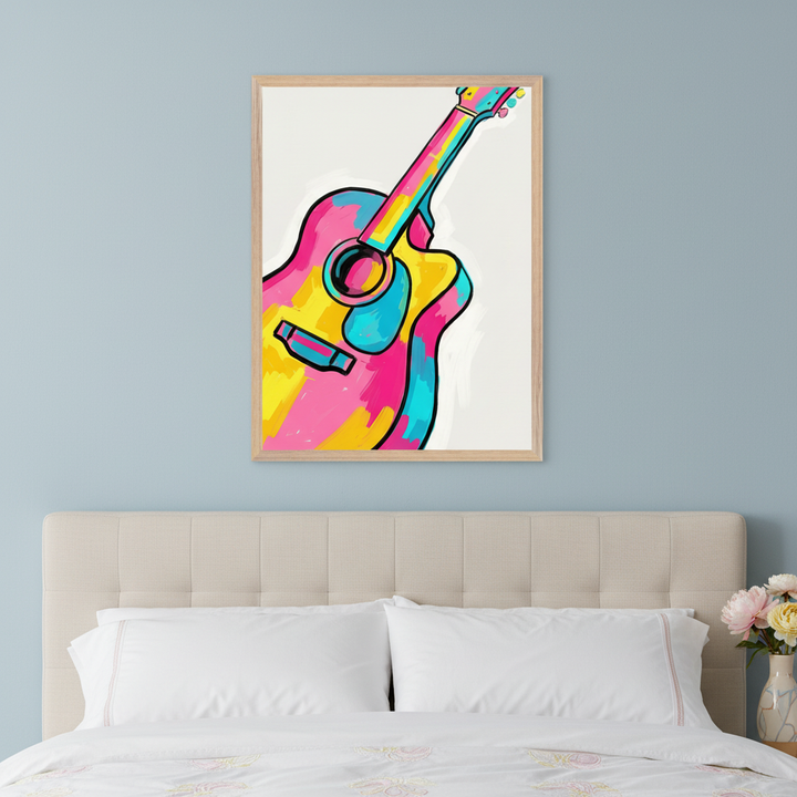 Modern bedroom with a beige upholstered headboard. A framed abstract print of a colorful guitar in pink, yellow, and turquoise hangs centered above the headboard.
