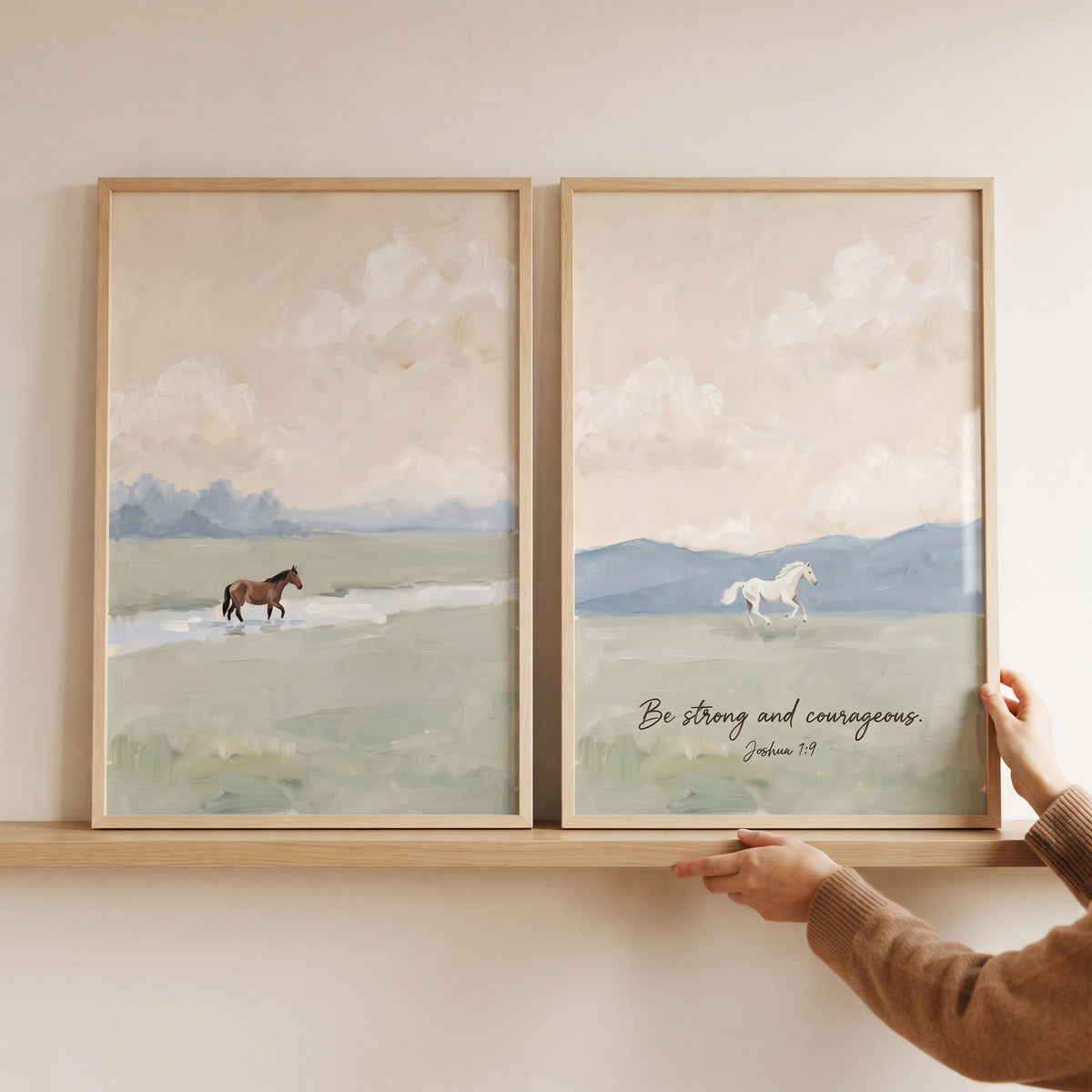 Hazy apricot sky horse wall art set of 2 with brown and white horses in fields and Joshua 1:9 scripture on a shelf.