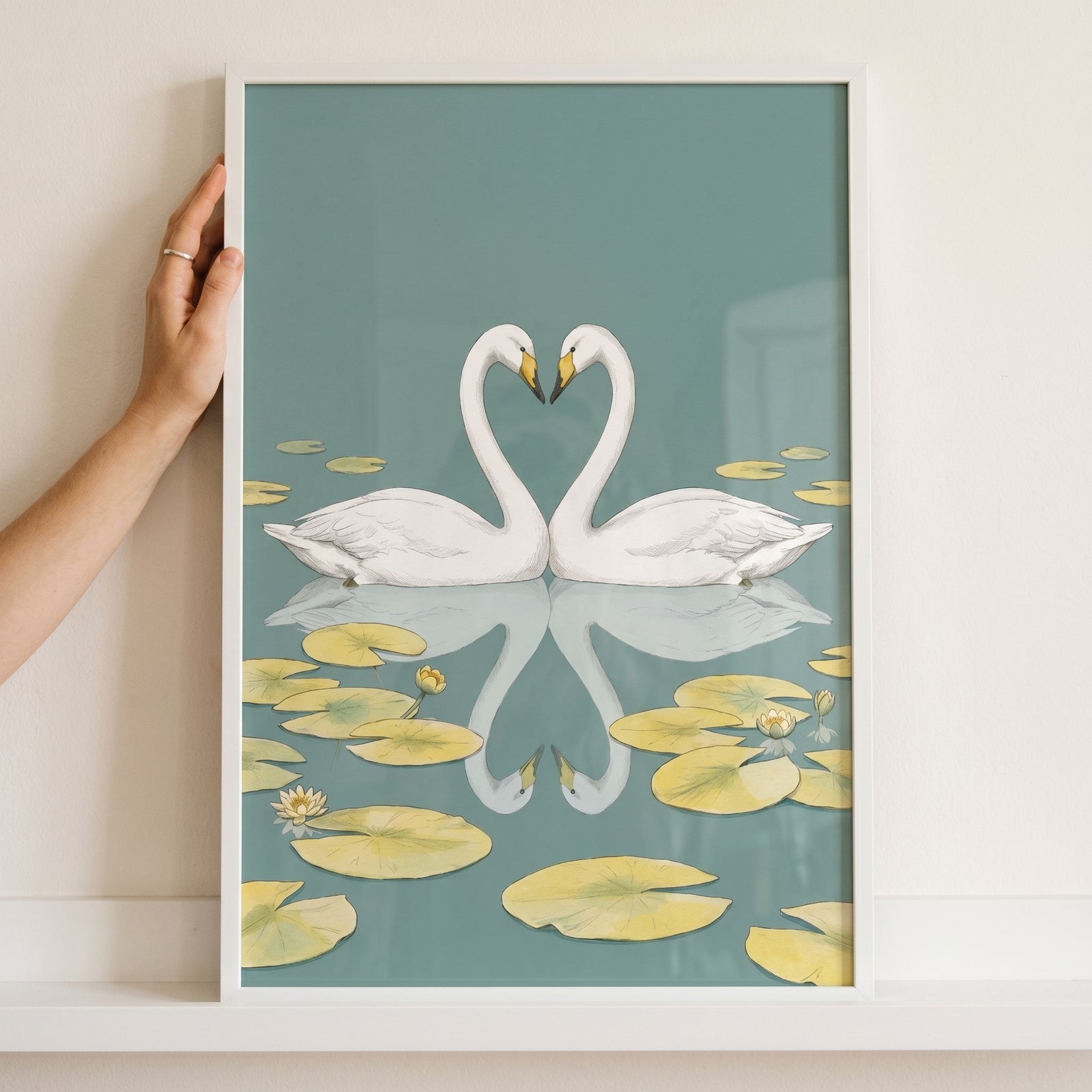 Heart neck white swan wall art shows two swans forming a heart with their necks above a pond with lily pads.