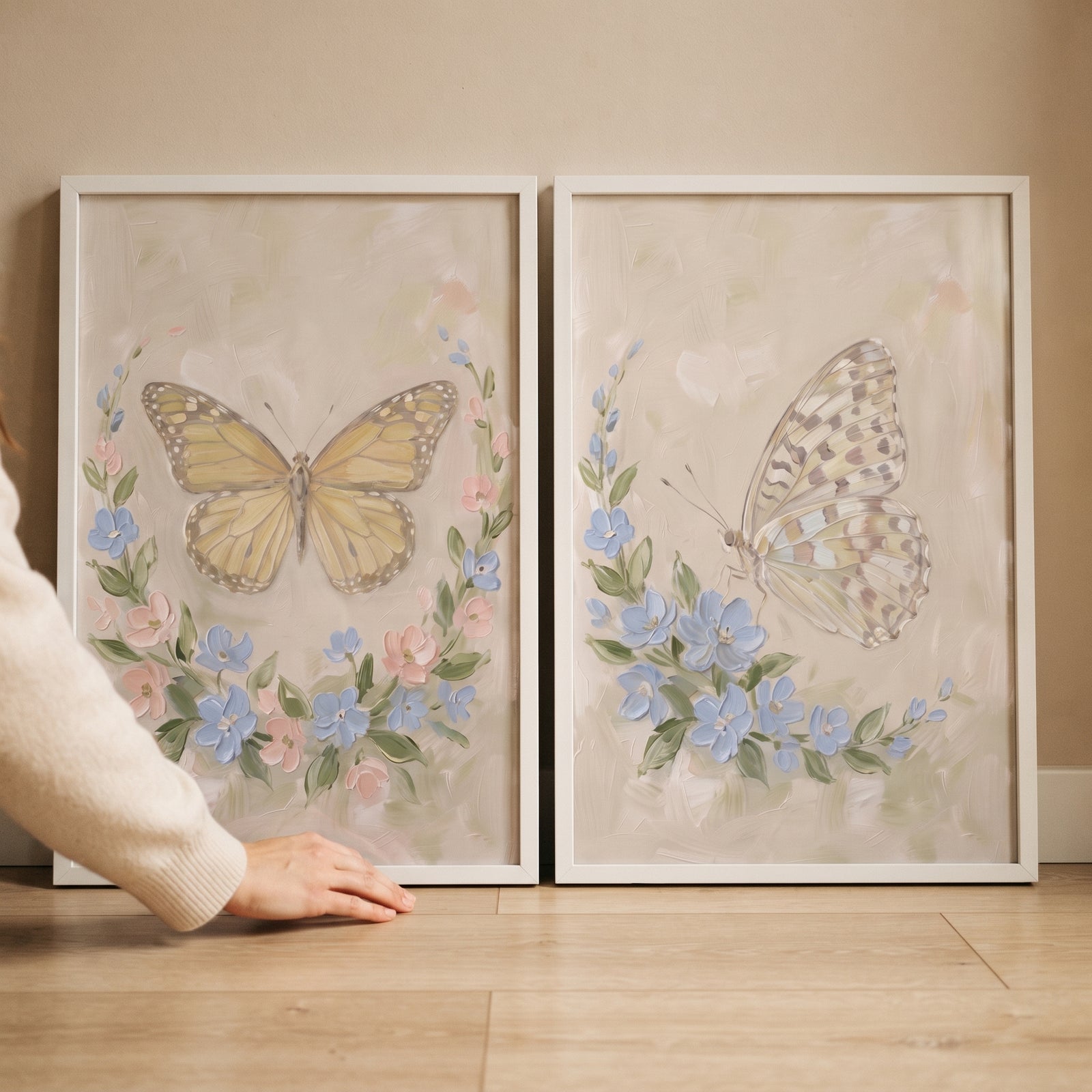 Heavy texture pastel butterfly wall art set of 2 in white frames with blue and pink flowers on a neutral backdrop.