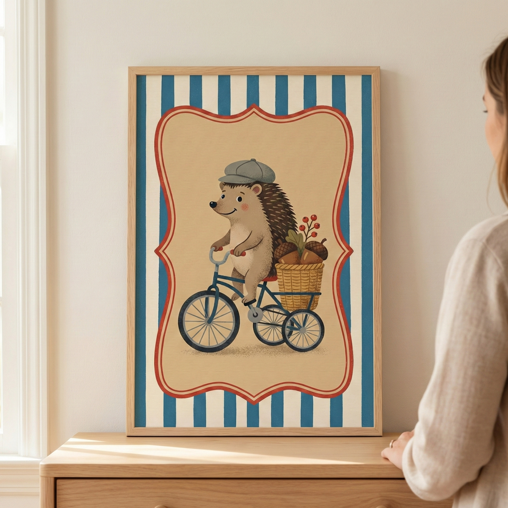 An illustration of a cheerful hedgehog riding a blue tricycle is presented in a light-colored wooden frame. The hedgehog, wearing a small grey flat cap, is pedaling along with a woven basket on the back of the trike, which is filled with large acorns and a sprig of red berries. The scene is centered within a cream-colored, scalloped-edge frame, set against a background of vertical blue and cream stripes. 