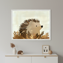 Framed illustration of a cute hedgehog nestled in autumn leaves, with soft brown and beige tones creating a cozy woodland vibe. The artwork is displayed above a modern dresser decorated with a hedgehog figurine, a white vase with a wooden leaf, and minimalist accessories for a warm, nature-themed interior.