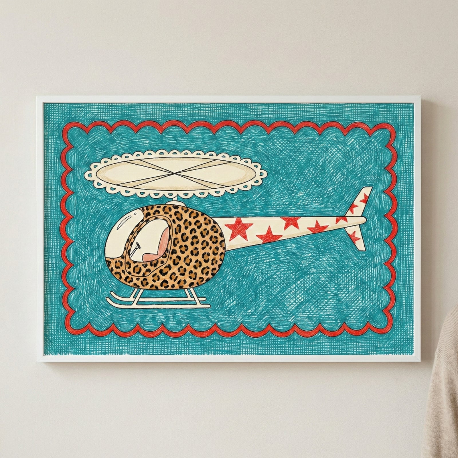 Framed artwork of a whimsical helicopter with a leopard-print front and red star-covered tail, set against a teal textured background with red scalloped edges, mounted on a light wall.