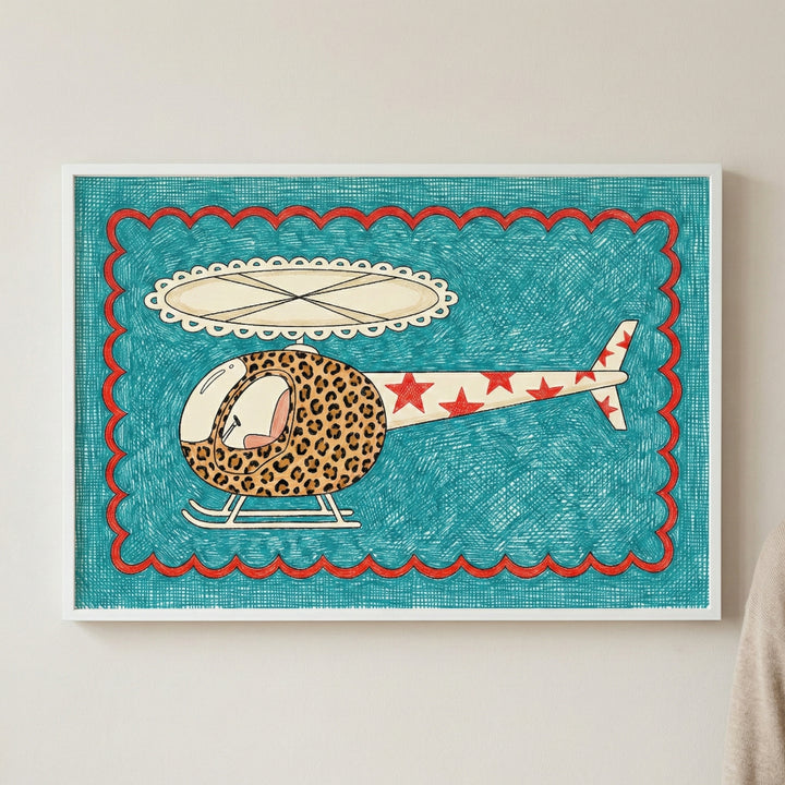Framed artwork of a whimsical helicopter with a leopard-print front and red star-covered tail, set against a teal textured background with red scalloped edges, mounted on a light wall.