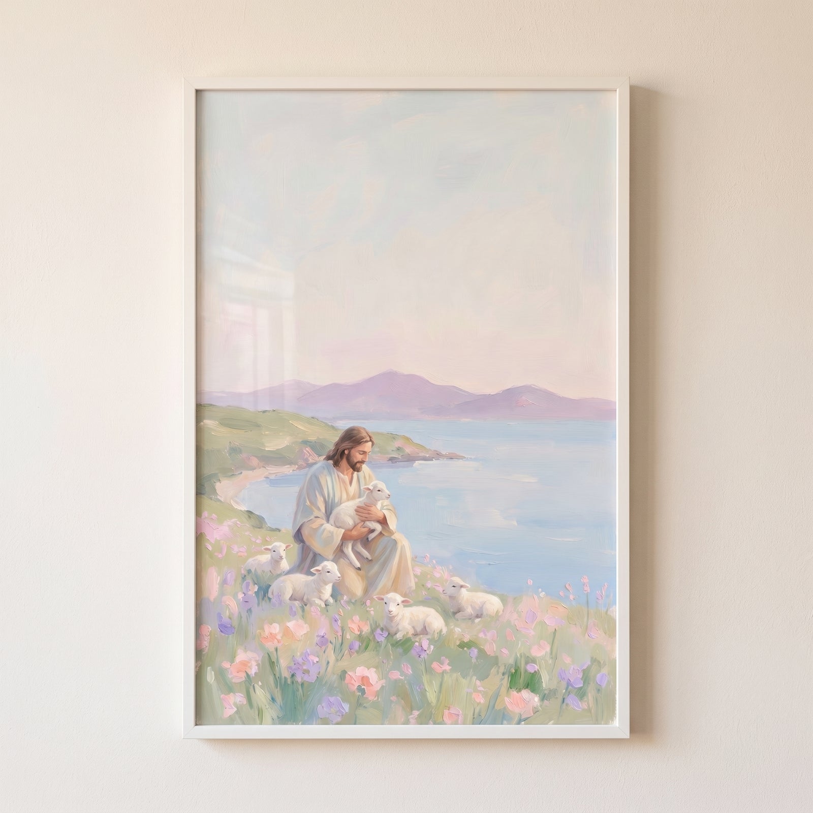 Jesus sits in a flowery coastal meadow with white lambs in soft pastel holding baby lamb jesus artwork.