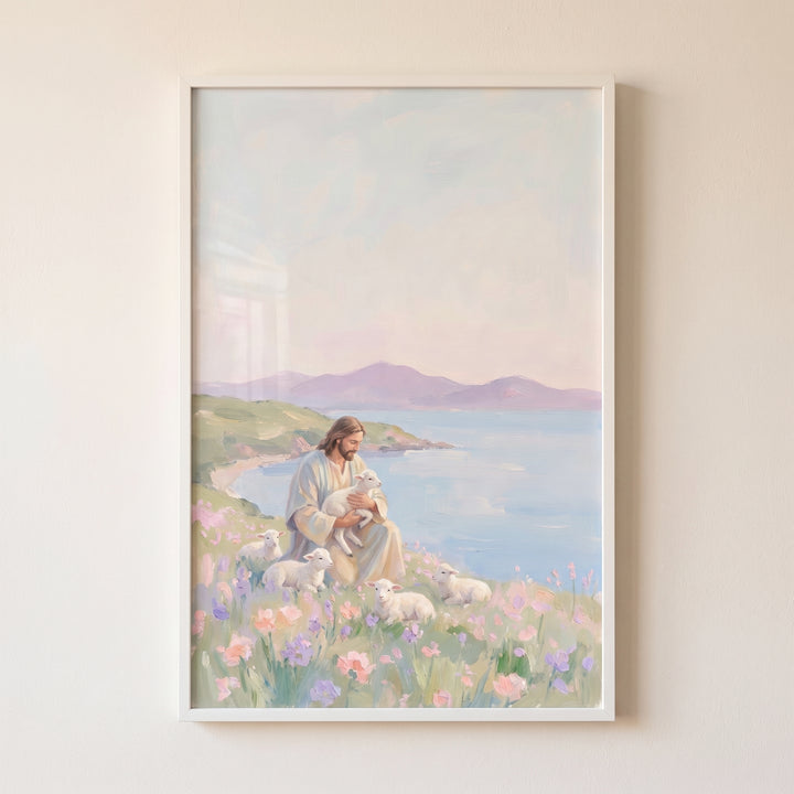 Jesus sits in a flowery coastal meadow with white lambs in soft pastel holding baby lamb jesus artwork.