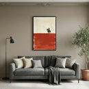 Western-themed painting of a cowboy riding a horse across a red desert, hanging above a modern gray sofa in a neutral-toned living room. The art contrasts a pale sky with a bold rust-colored terrain, adding a rustic yet contemporary touch to the decor.